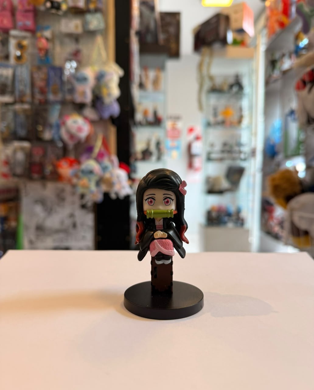 FIGURA DE NEZUKO SENTADA SOBRE CAJON